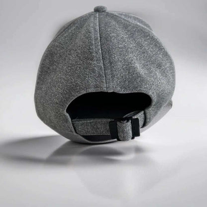 Premium grey cap with adjustable strap and breathable fabric.