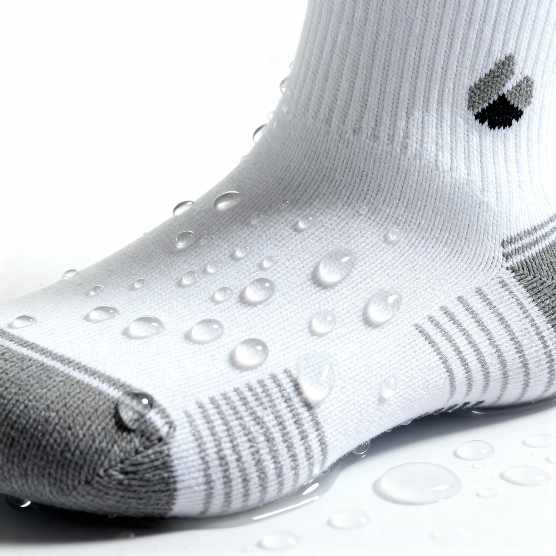 white and grey ankle running socks with water droplets showcasing moisture-wicking fabric and breathable design