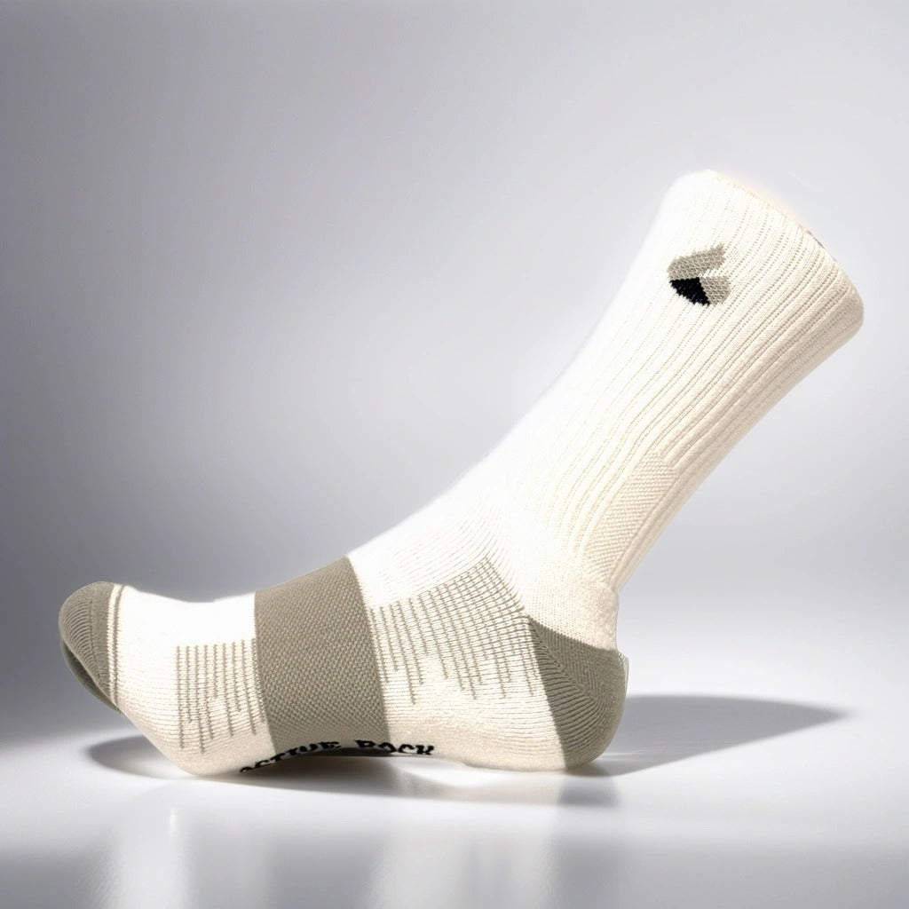 White and grey crew tennis socks with Active Arc compression and seamless toe design.
